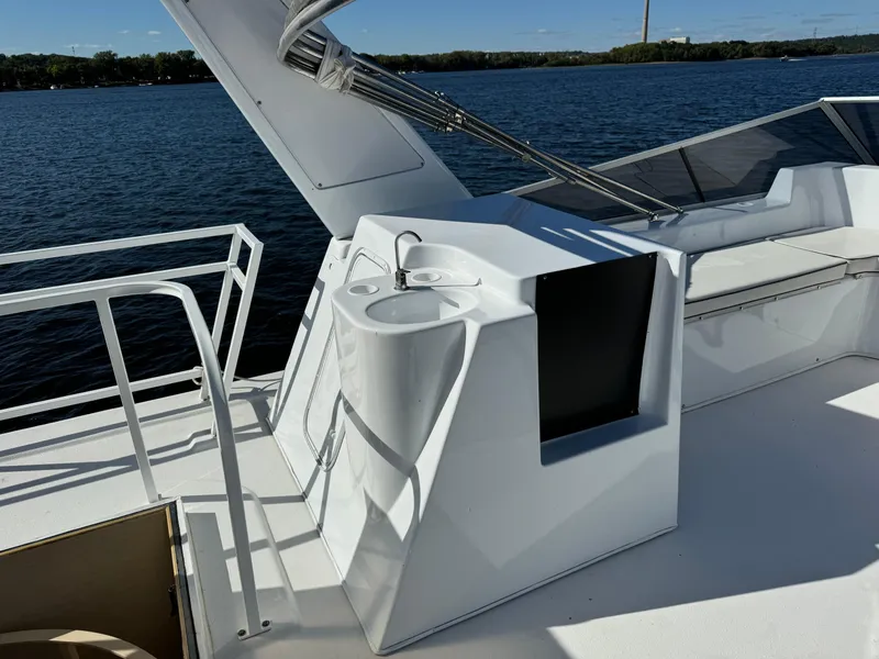 Slide: The Image of 1996 Skipperliner 560 Coastal Cruiser deck with sink, railing, and water view. - 5