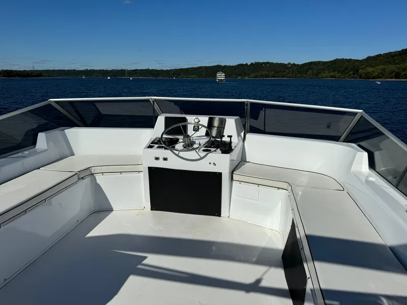 Slide: The Image of 1996 Skipperliner 560 Coastal Cruiser helm with panoramic water view. - 6
