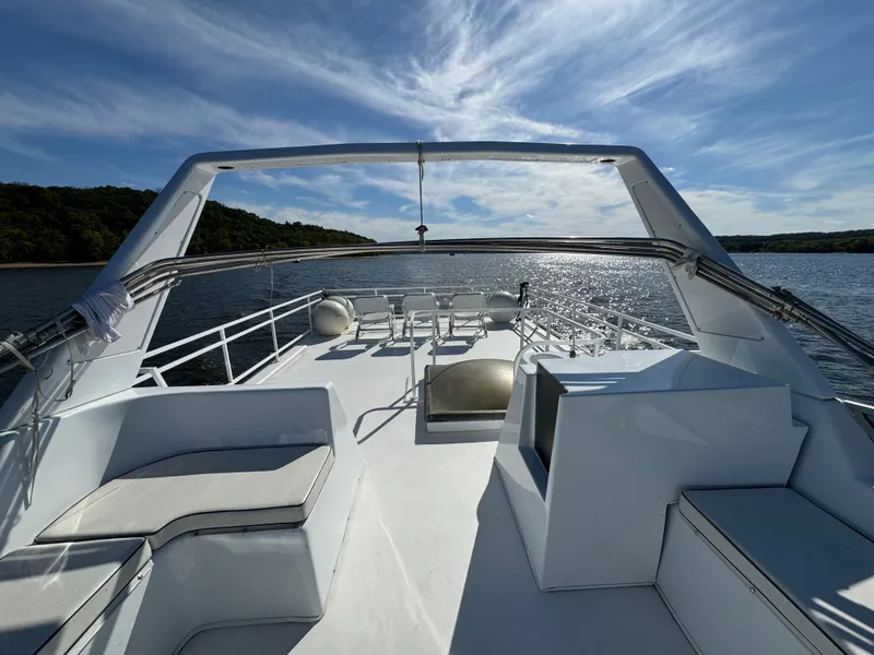 Slide: The Image of 1996 Skipperliner 560 Coastal Cruiser on serene water under a clear blue sky. - 8