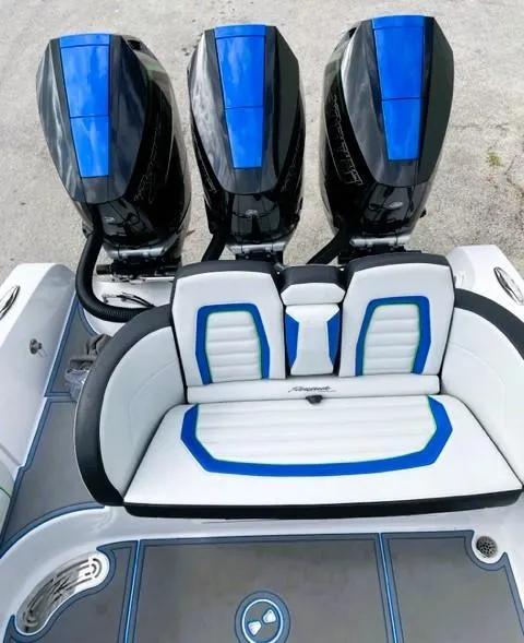Slide: The Image of 2025 Renegade 38 Open boat with triple outboard engines and stylish blue-accented seating. - 7