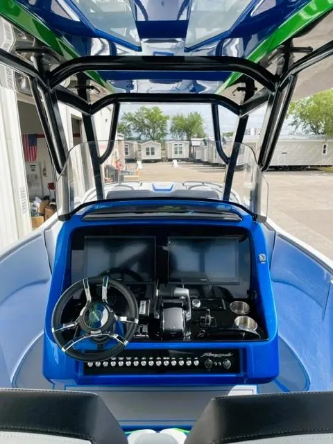 Slide: The Image of 2025 Renegade 38 Open boat cockpit with modern controls and dual screens. - 9