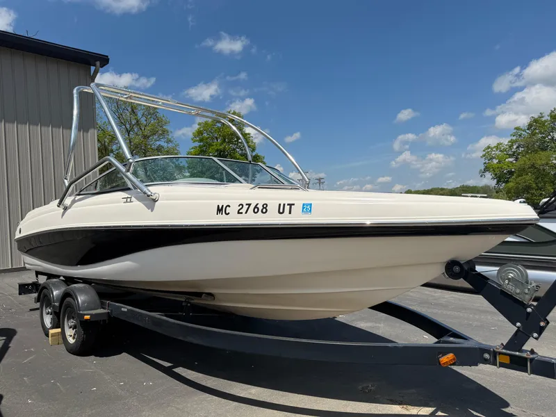 Slide: The Image of 2004 Rinker Captiva boat on trailer under clear blue sky. - 0