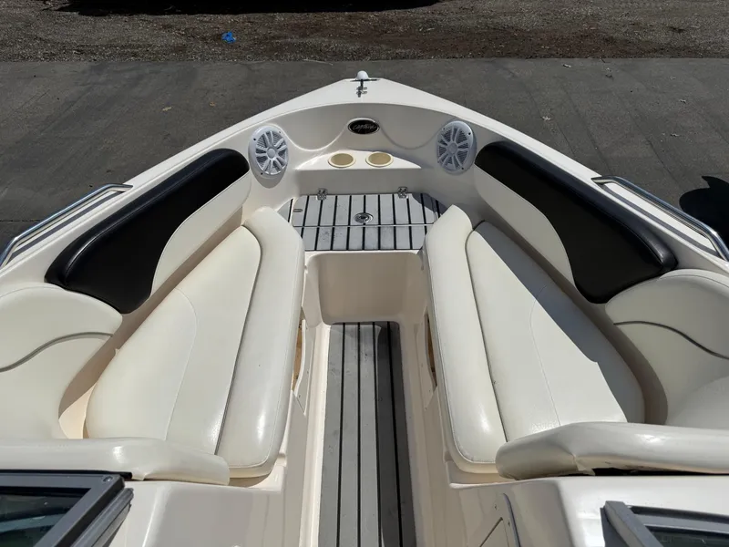 Slide: The Image of 2004 Rinker Captiva boat interior with white seating and speakers. - 12