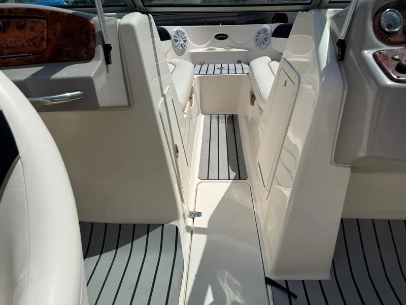 Slide: The Image of 2004 Rinker Captiva boat interior with seating, speakers, and wood accents. - 13