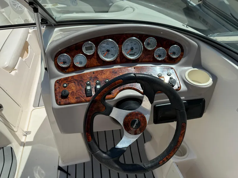 Slide: The Image of 2004 Rinker Captiva boat dashboard with steering wheel and instrument panel. - 15