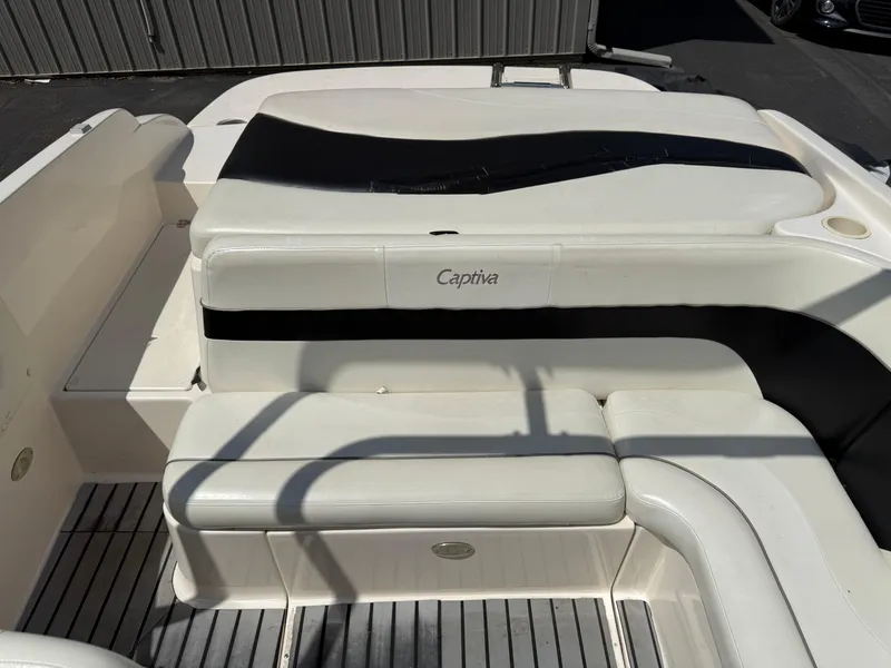 Slide: The Image of 2004 Rinker Captiva boat interior with white and black seating. - 16