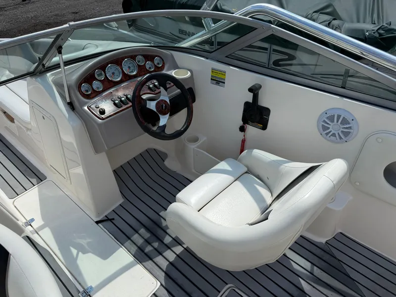 Slide: The Image of 2004 Rinker Captiva boat interior with steering wheel and dashboard controls. - 18