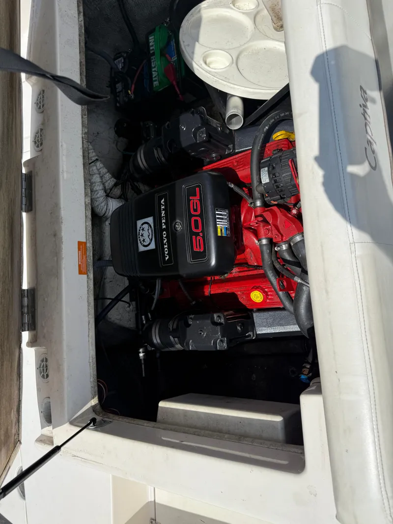 Slide: The Image of 2004 Rinker Captiva boat engine compartment with visible red engine components. - 21