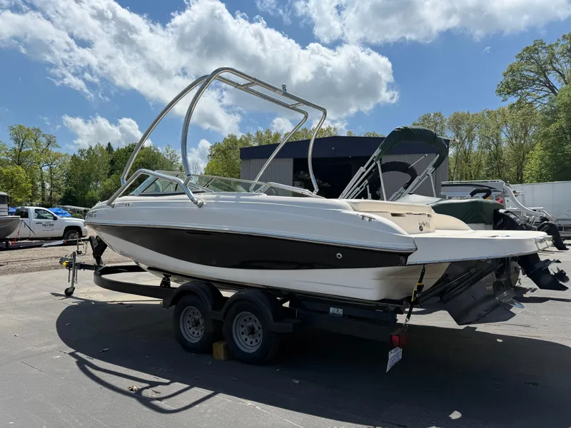 Slide: The Image of 2004 Rinker Captiva boat on trailer under a partly cloudy sky. - 3