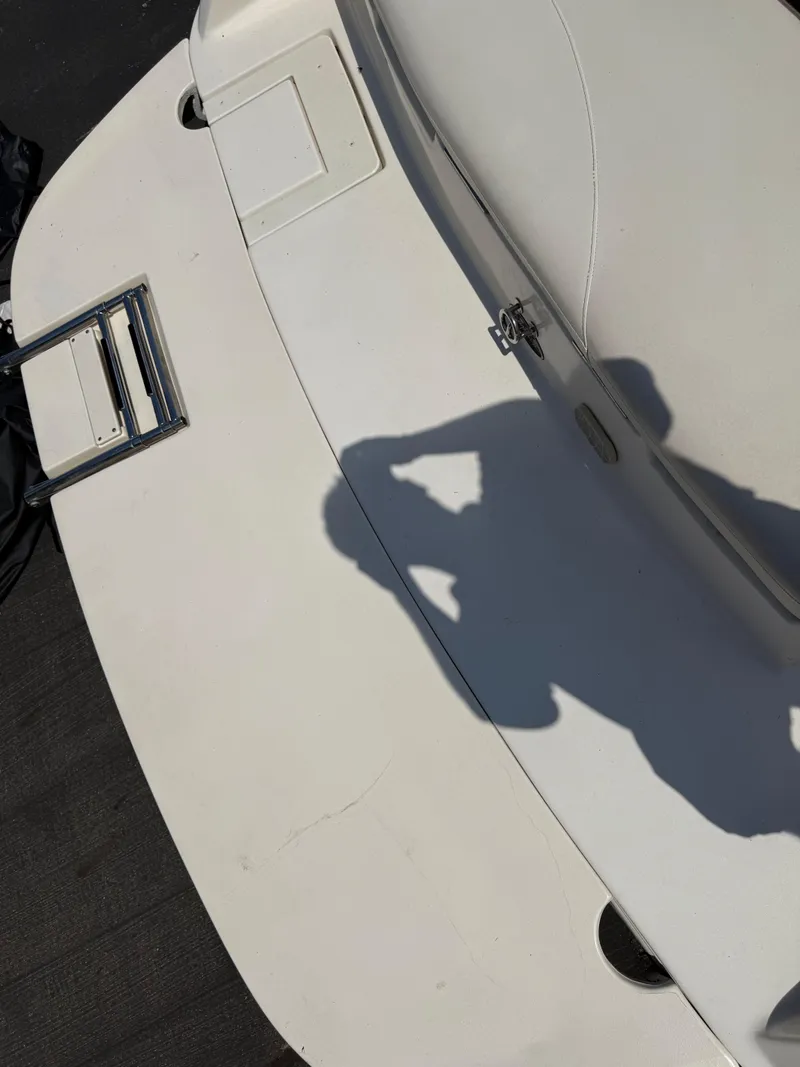 Slide: The Image of 2004 Rinker Captiva boat deck with shadow and hatch detail. - 7