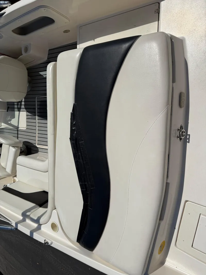 Slide: The Image of 2004 Rinker Captiva boat seat with white and black upholstery. - 8