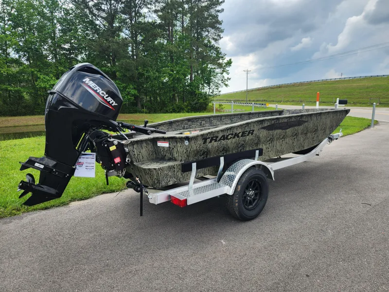 Slide: The Image of 2025 Tracker Grizzly 1650 T Prairie Wings Edition boat on trailer, outdoors. - 2