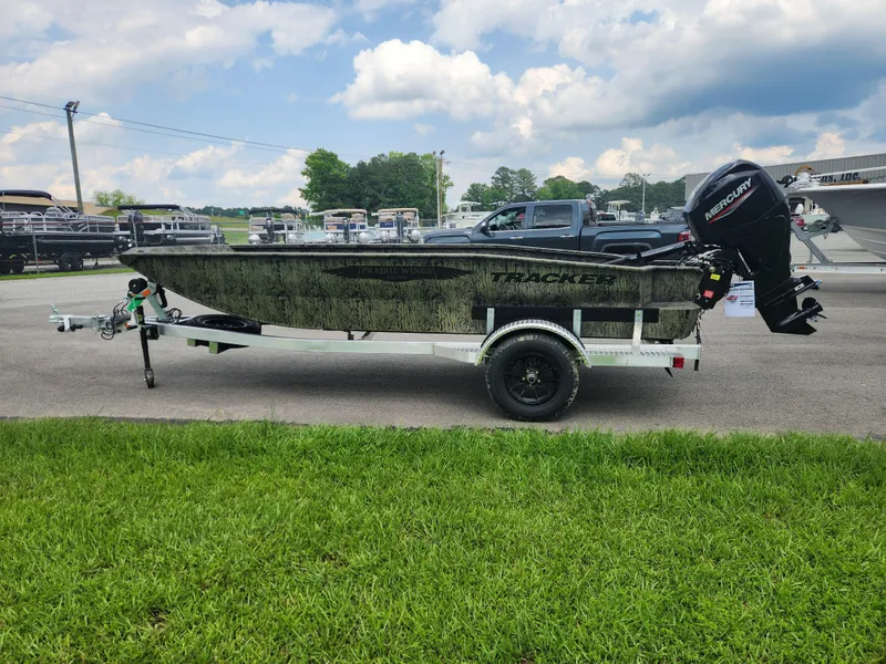 Slide: The Image of 2025 Tracker Grizzly 1650 T Prairie Wings Edition boat on trailer, parked outdoors. - 5
