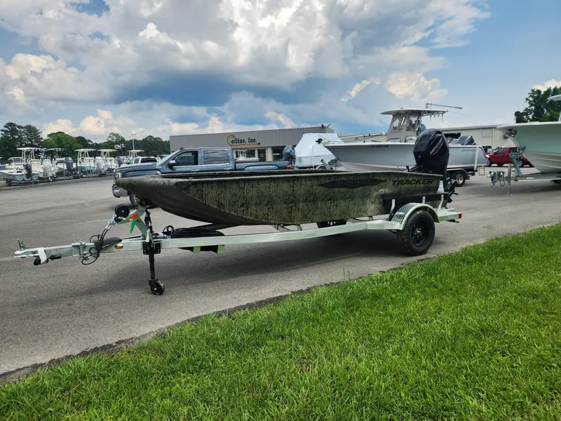 Slide: The Image of 2025 Tracker Grizzly 1650 T Prairie Wings Edition boat on trailer, parked outdoors. - 6