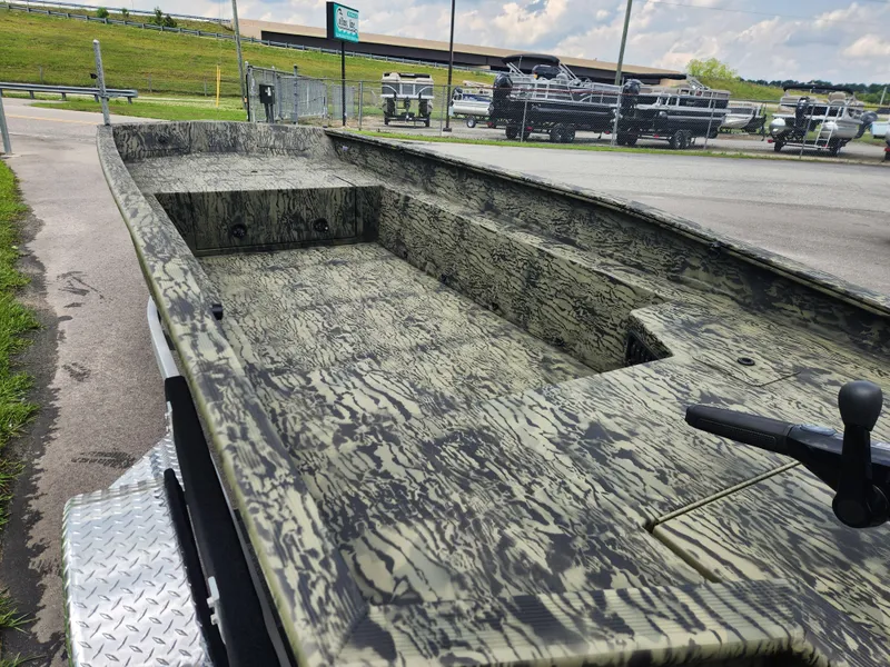 Slide: The Image of 2025 Tracker Grizzly 1650 T Prairie Wings Edition boat with camouflage design on a trailer. - 7