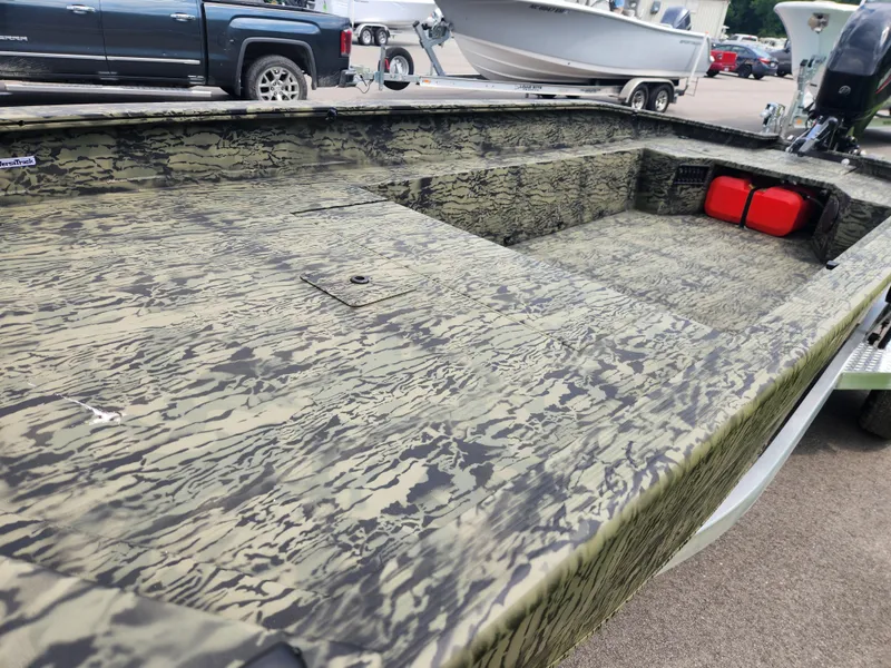 Slide: The Image of 2025 Tracker Grizzly 1650 T Prairie Wings Edition boat with camouflage design and spacious interior. - 8
