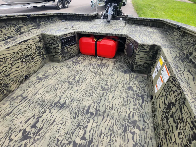 Slide: The Image of 2025 Tracker Grizzly 1650 T Prairie Wings Edition boat with camouflage interior and red fuel tank. - 9