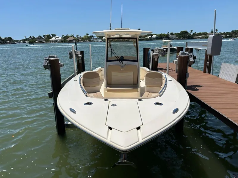 Slide: The Image of 2023 Scout 277 LXF boat docked on a sunny day. - 9