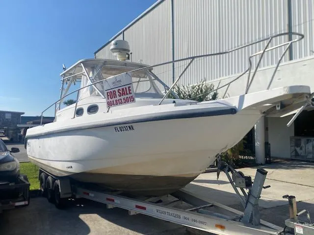 Slide: The Image of 2001 Boston Whaler 28 Conquest boat for sale on trailer, outdoor setting. - 1