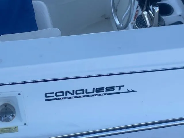 Slide: The Image of Boston Whaler 28 Conquest boat, 2001 model, featuring steering wheel and cockpit details. - 11