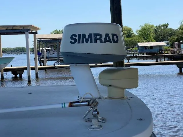 Slide: The Image of Simrad radar on 2001 Boston Whaler 28 Conquest boat docked by the water. - 13