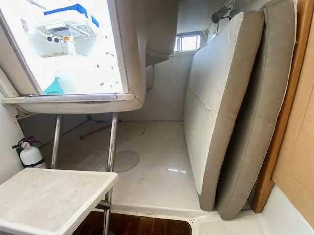 Slide: The Image of Interior cabin of 2001 Boston Whaler 28 Conquest boat with cushions and ladder. - 16