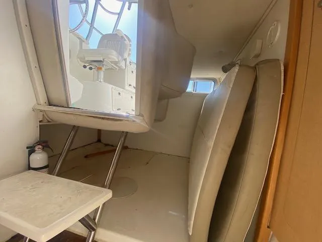 Slide: The Image of 2001 Boston Whaler 28 Conquest cabin interior with seating and helm view. - 20