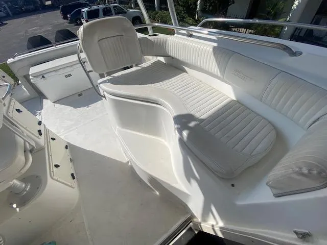 Slide: The Image of 2001 Boston Whaler 28 Conquest boat interior with white cushioned seating. - 22