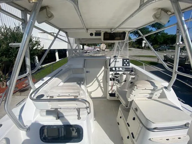 Slide: The Image of 2001 Boston Whaler 28 Conquest boat interior with seating and control panel. - 23