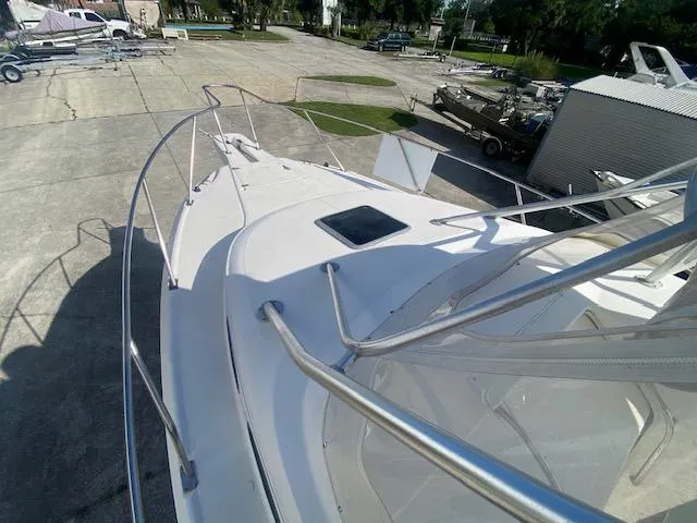 Slide: The Image of 2001 Boston Whaler 28 Conquest boat deck with railing, docked on concrete. - 27