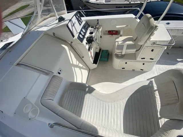 Slide: The Image of 2001 Boston Whaler 28 Conquest boat interior with seating and control panel. - 28