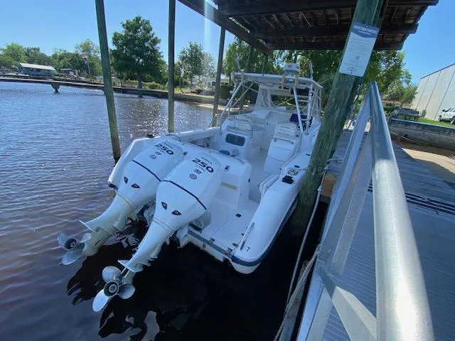 Slide: The Image of 2001 Boston Whaler 28 Conquest docked with twin outboard engines. - 3