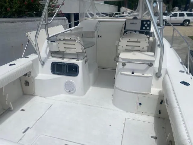 Slide: The Image of 2001 Boston Whaler 28 Conquest boat interior with seating and control panel. - 36