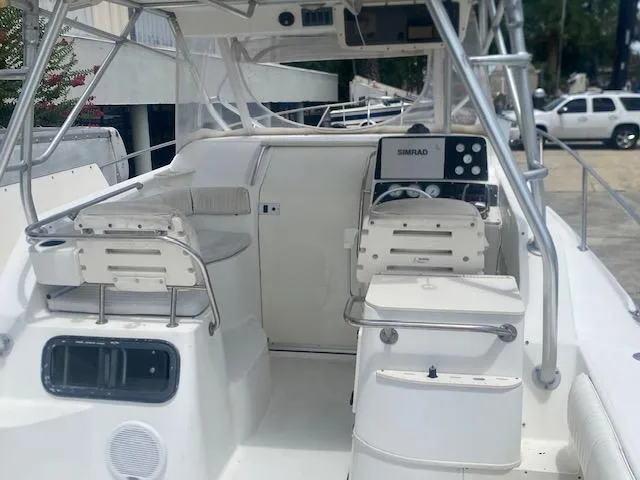 Slide: The Image of 2001 Boston Whaler 28 Conquest boat interior with seating and control panel. - 37