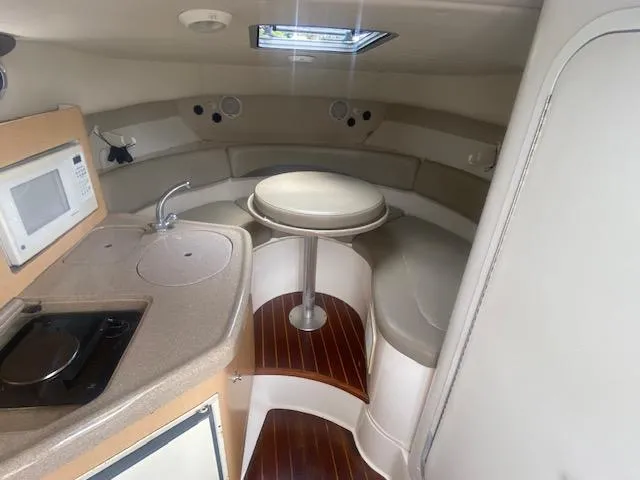 Slide: The Image of Interior of 2001 Boston Whaler 28 Conquest boat with kitchenette and seating area. - 39