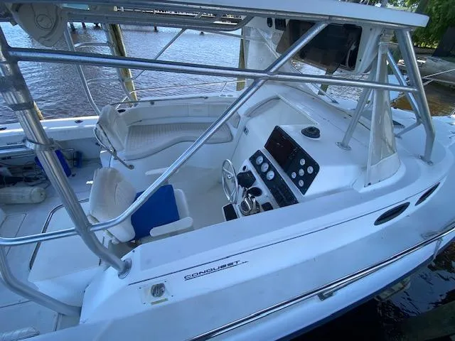 Slide: The Image of 2001 Boston Whaler 28 Conquest boat interior with steering console and seating. - 5