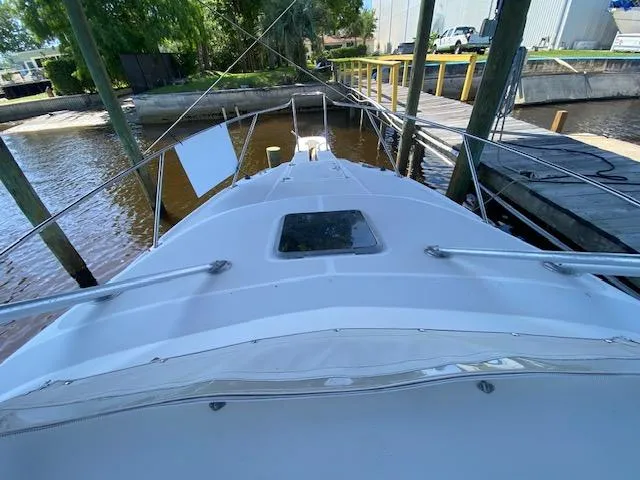 Slide: The Image of 2001 Boston Whaler 28 Conquest boat docked at a marina, viewed from the bow. - 7