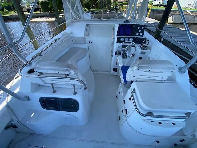 Slide: The Image of 2001 Boston Whaler 28 Conquest boat interior with seating and control panel. - 9