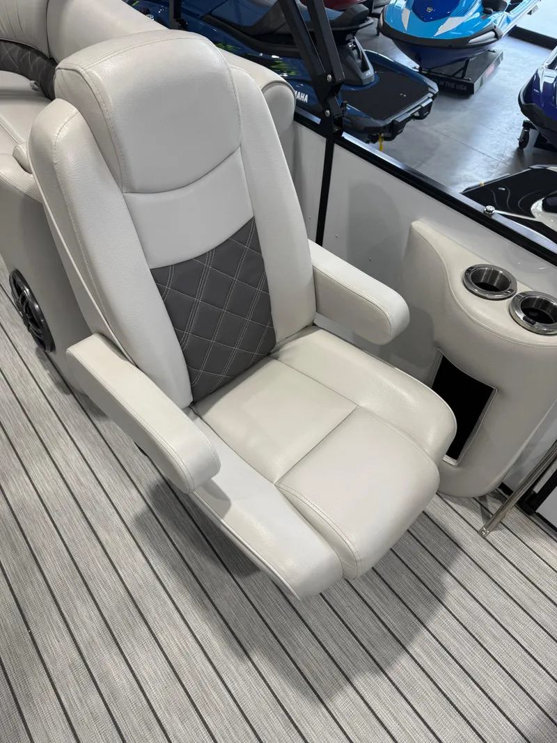 Slide: The Image of 2024 G3 Elite 324RC boat seat with cup holders on striped flooring. - 10