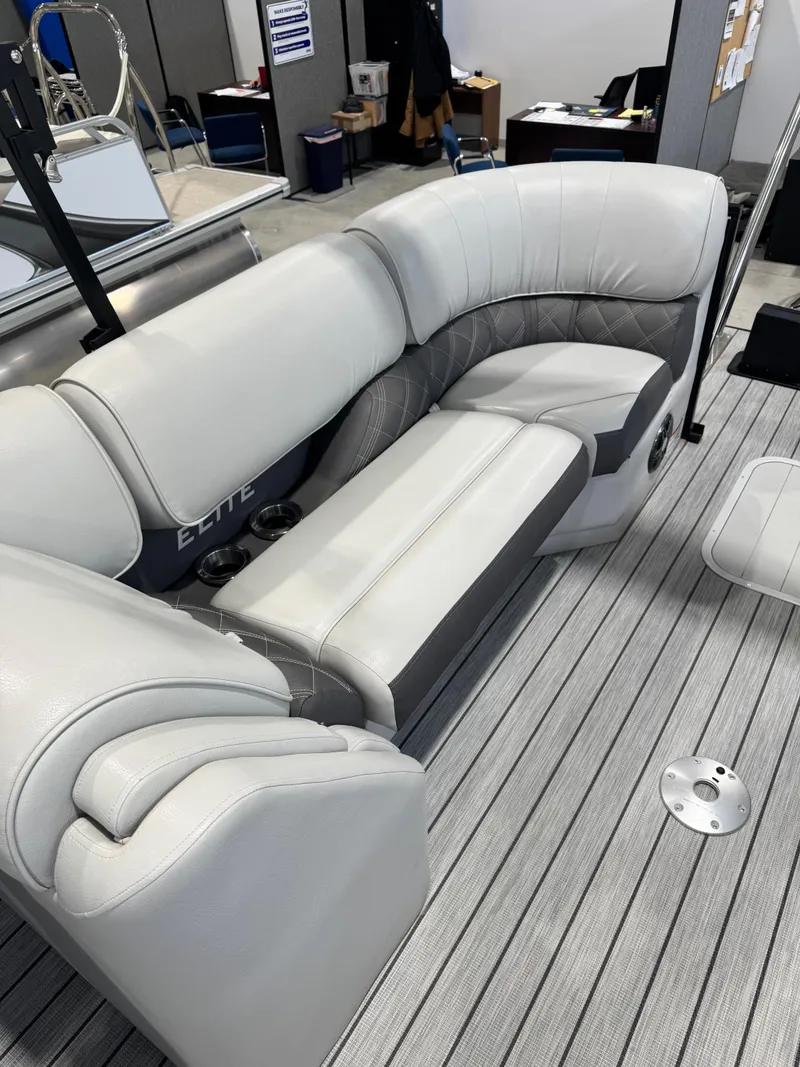 Slide: The Image of 2024 G3 Elite 324RC boat interior with plush gray seating and striped flooring. - 12