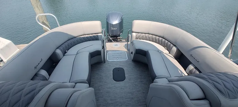 Slide: The Image of 2021 Bennington RX 25 RXFBA pontoon boat with luxurious seating and Yamaha motor on calm water. - 10