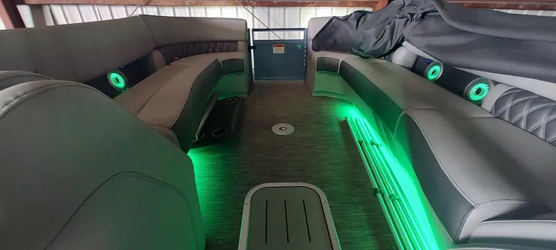 Slide: The Image of 2021 Bennington RX 25 RXFBA interior with green LED lighting and luxurious seating. - 15