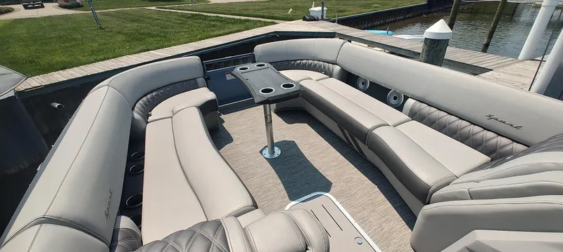 Slide: The Image of 2021 Bennington RX 25 RXFBA pontoon boat with luxurious seating and table setup. - 3