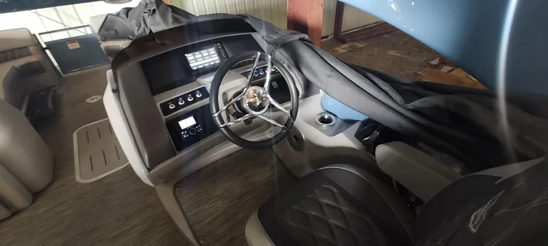 Slide: The Image of 2021 Bennington RX 25 RXFBA boat interior with steering wheel and control panel. - 8