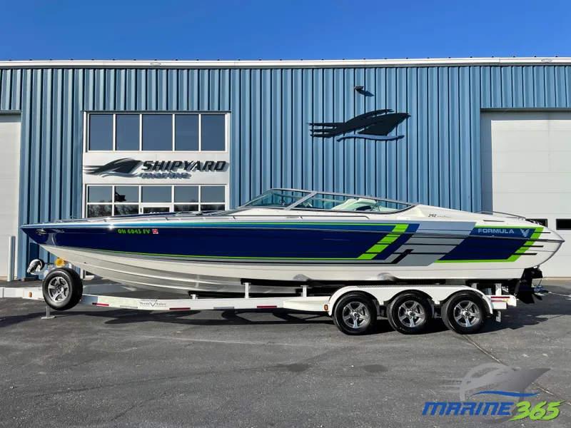 Slide: The Image of 2018 Formula 292 FASTech boat on trailer, parked outside a shipyard building. - 0