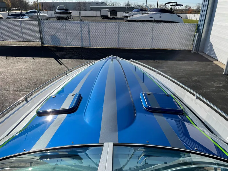 Slide: The Image of 2018 Formula 292 FASTech boat with sleek blue and gray design, parked outdoors. - 10