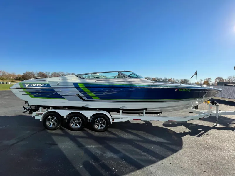 Slide: The Image of 2018 Formula 292 FASTech speedboat on a trailer, parked outdoors under clear blue sky. - 6