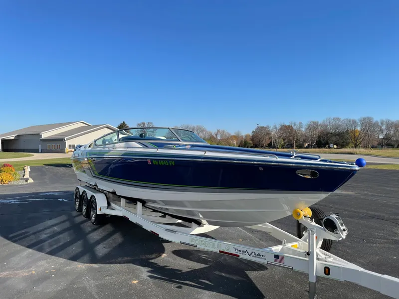 Slide: The Image of 2018 Formula 292 FASTech boat on trailer, parked outdoors under clear blue sky. - 7