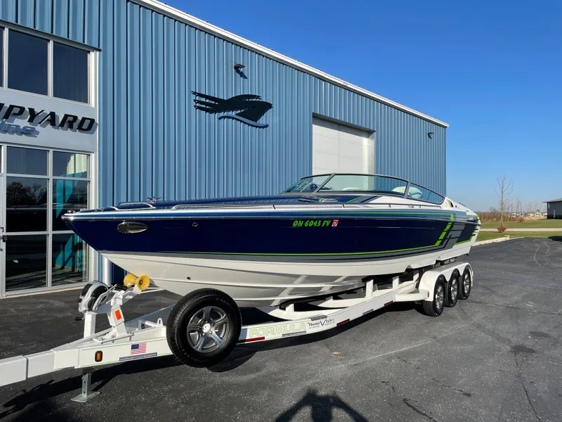 Slide: The Image of 2018 Formula 292 FASTech boat on trailer outside blue building. - 8
