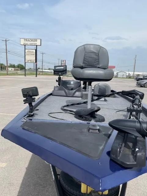 Slide: The Image of 2020 Tracker Pro 170 boat with fishing seat and equipment, parked outdoors. - 6